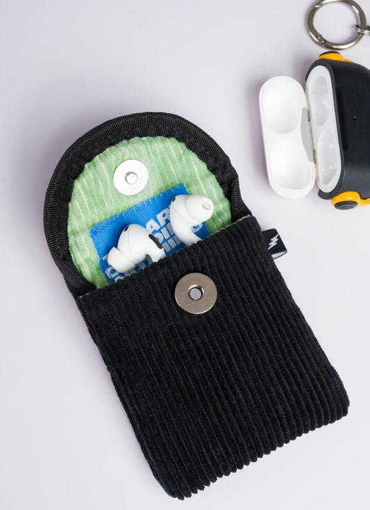 Open mini corduroy pouch showing earpods and magnetic closure